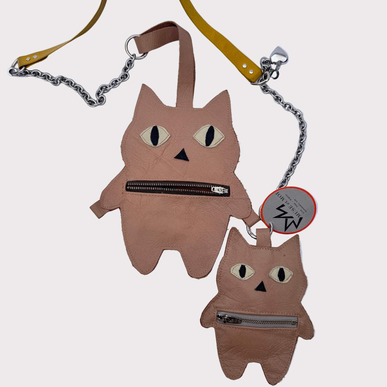 Two cat-shaped bags with a chain strap on a light-gray background