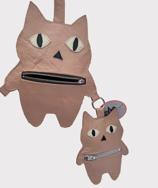 Cat-shaped pouches with zippers on a light gray background