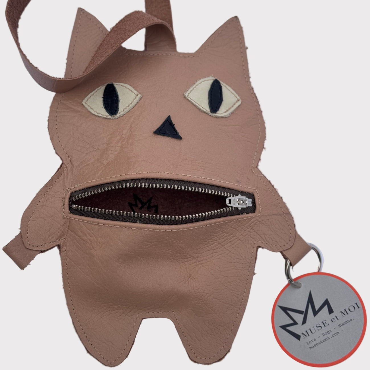 Cat-shaped bag with a visible brand tag on a white background