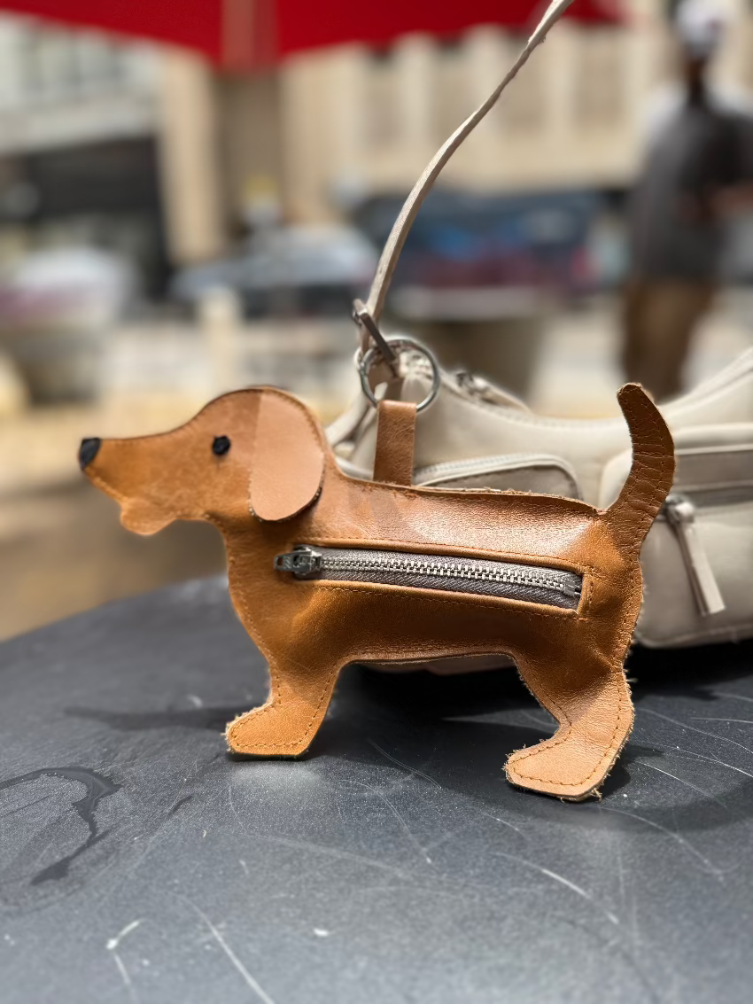 Le-Sniffer-Waste-bag-Dispenser-for-dogs-from-Muse-et-moi-brown-leather-with-zipper-dog-silhouette-as-a-charm-attached-to-a-handbag