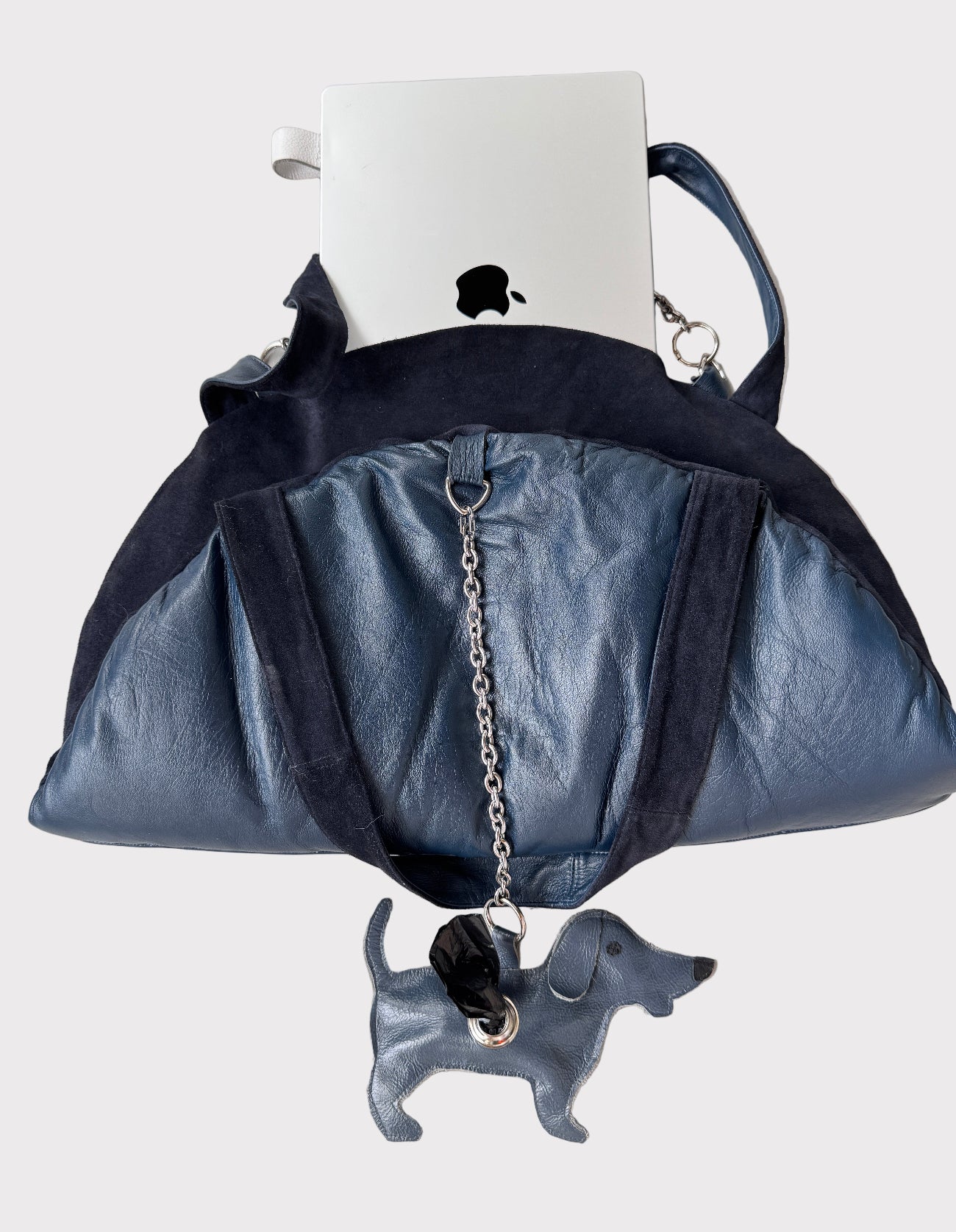 Blue handbag with chain detail on a white surface