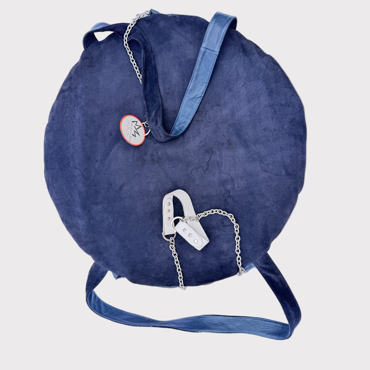 Blue round bag with a chain detail on a light grey background