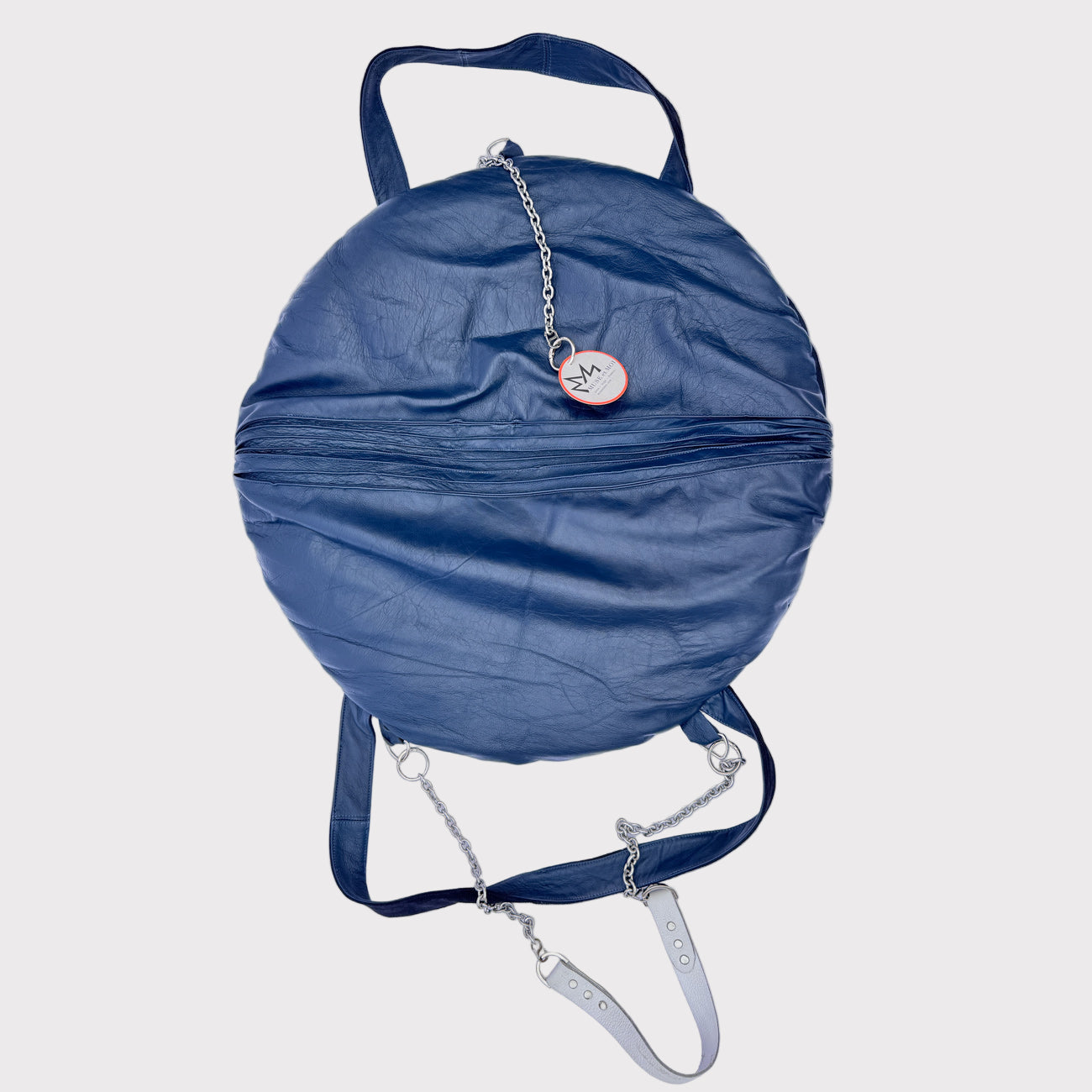 Blue round bag with a chain strap on a light gray background