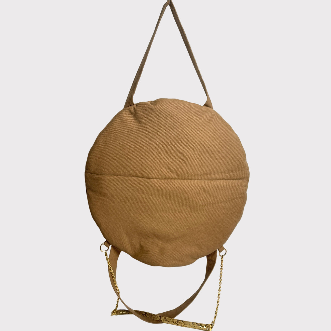A circular cushion dog bed and computer tote bag with a shoulder straps and cross body chain+leather strap