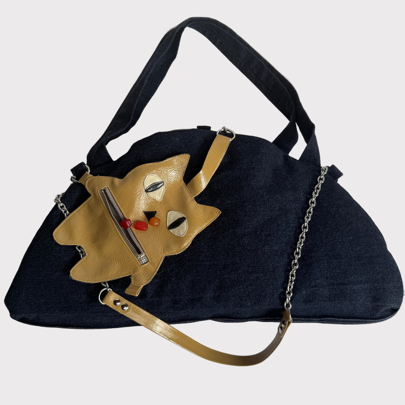 a denim computer bag/dog bed with a dog treat + poop bag holder pouch as charm