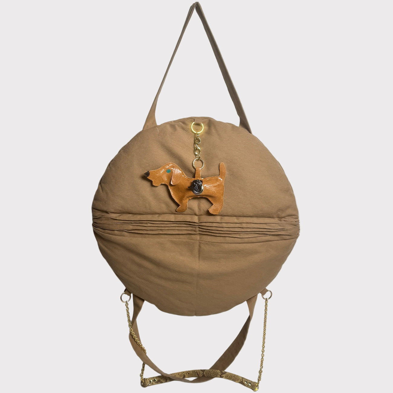 right side of the bark-bed-pro-denim tote with a small dog charm that is a dog poop bag dispenser