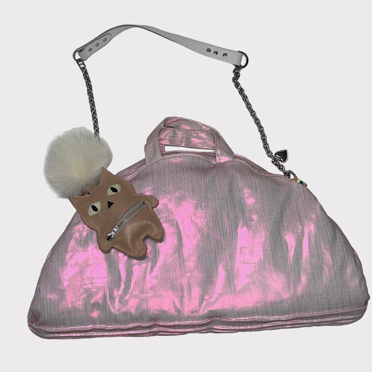 Pink and gray handbag with a small  cat charm on a white background