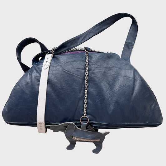 Blue leather bag with chain detail on a light gray background