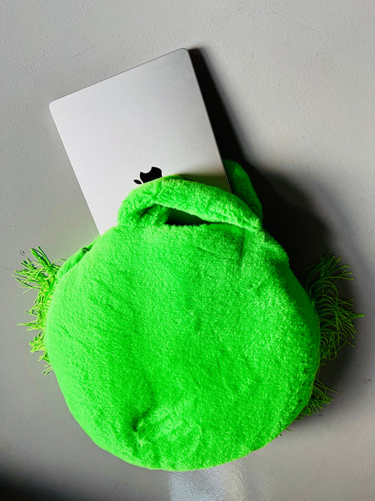 A dog bed/computer bag in one, round with fringes and 